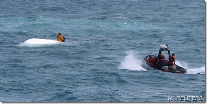 Nick Schuyler sits atop an overturned boat 1 maza